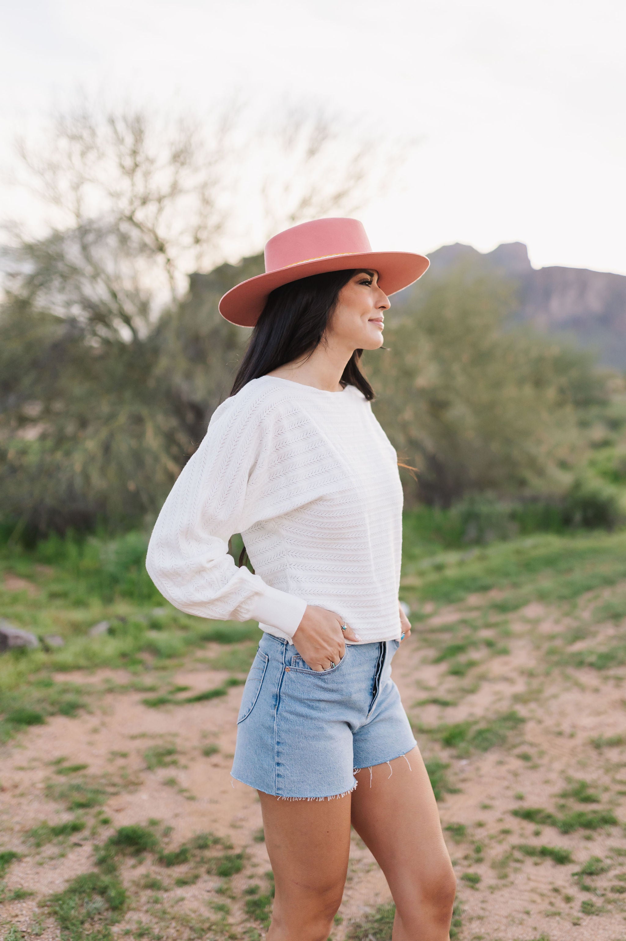 Side view of Astrid sweater with pointelle knit, dolman sleeves, and boat neck. 