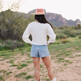 Rear view of Astrid sweater with pointelle knit, dolman sleeves, and boat neck. 