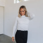 Front view of cropped white Mock Turtle Neck.