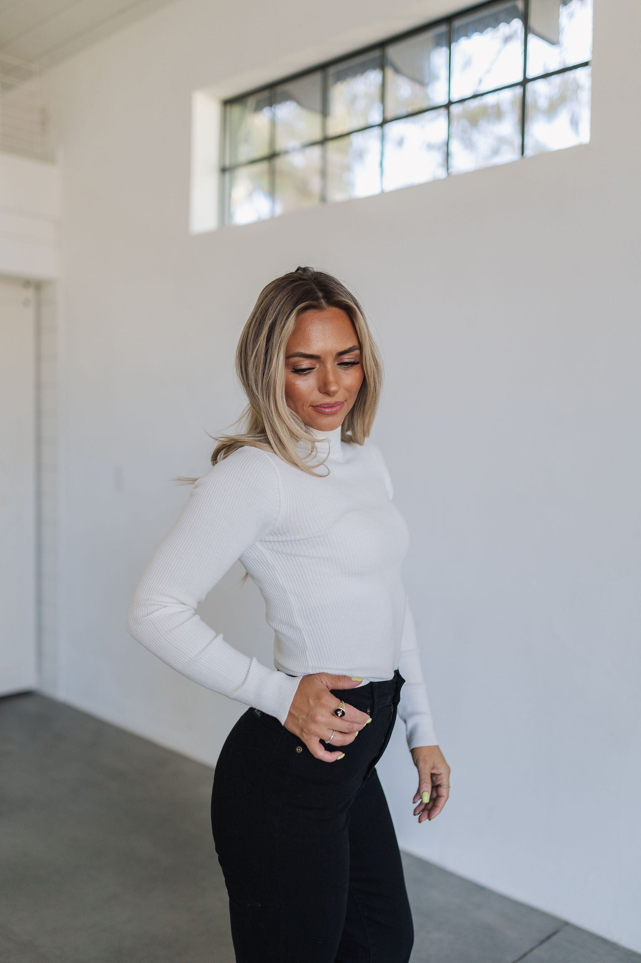 Front angled view of cropped white Mock Turtle Neck.