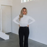 Front view of cropped white Mock Turtle Neck.