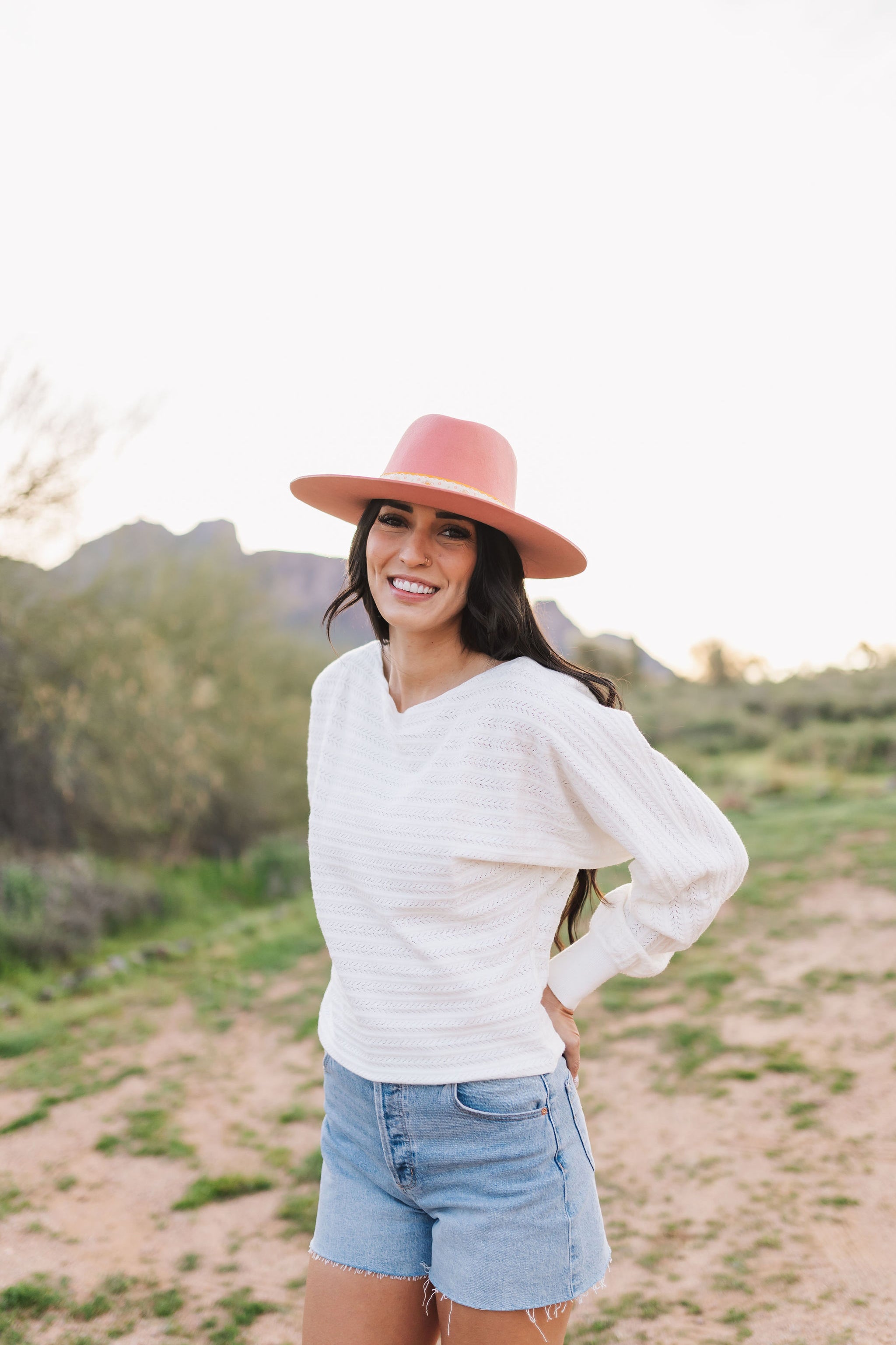 Front angled view of Astrid sweater with pointelle knit, dolman sleeves, and boat neck. 