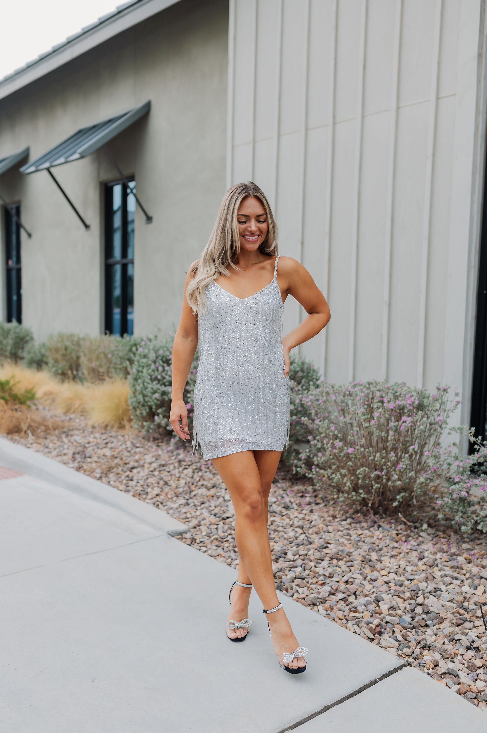 Front view of Sparks Fly Mini Dress with thin straps and allover fringe and sequin details. 