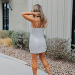 Rear view of Sparks Fly Mini Dress with thin straps and allover fringe and sequin details. 