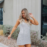 Front view of Sparks Fly Mini Dress with thin straps and allover fringe and sequin details. 