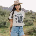 Front view of cropped Let's Go Girls Graphic Tee with a mineral wash, distressed graphic, and raw hem.  