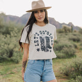 Front view of cropped Let's Go Girls Graphic Tee with a mineral wash, distressed graphic, and raw hem.  