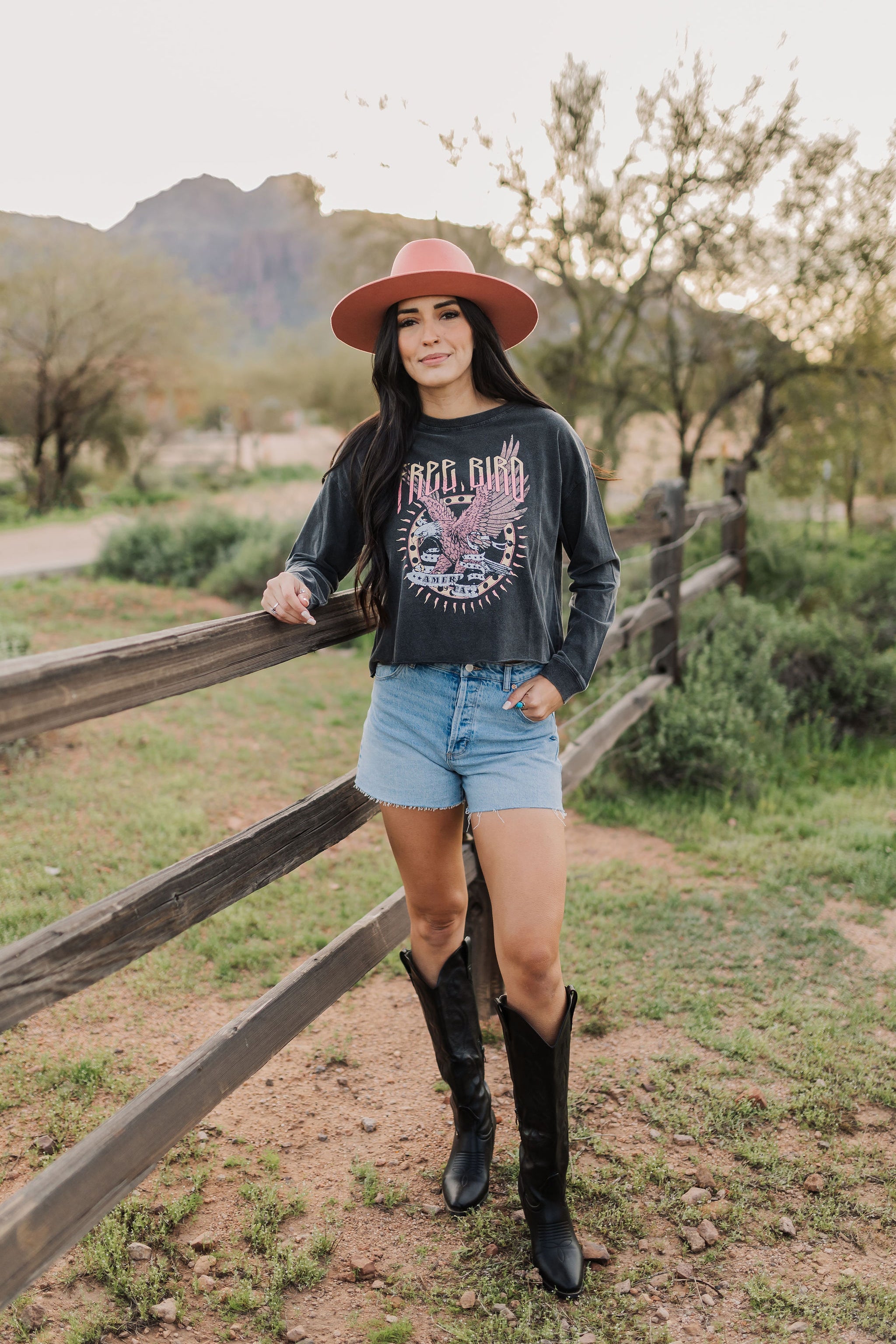 Front view of cropped Freebird Long Sleeve Graphic Tee with distressed graphic and raw hem. 