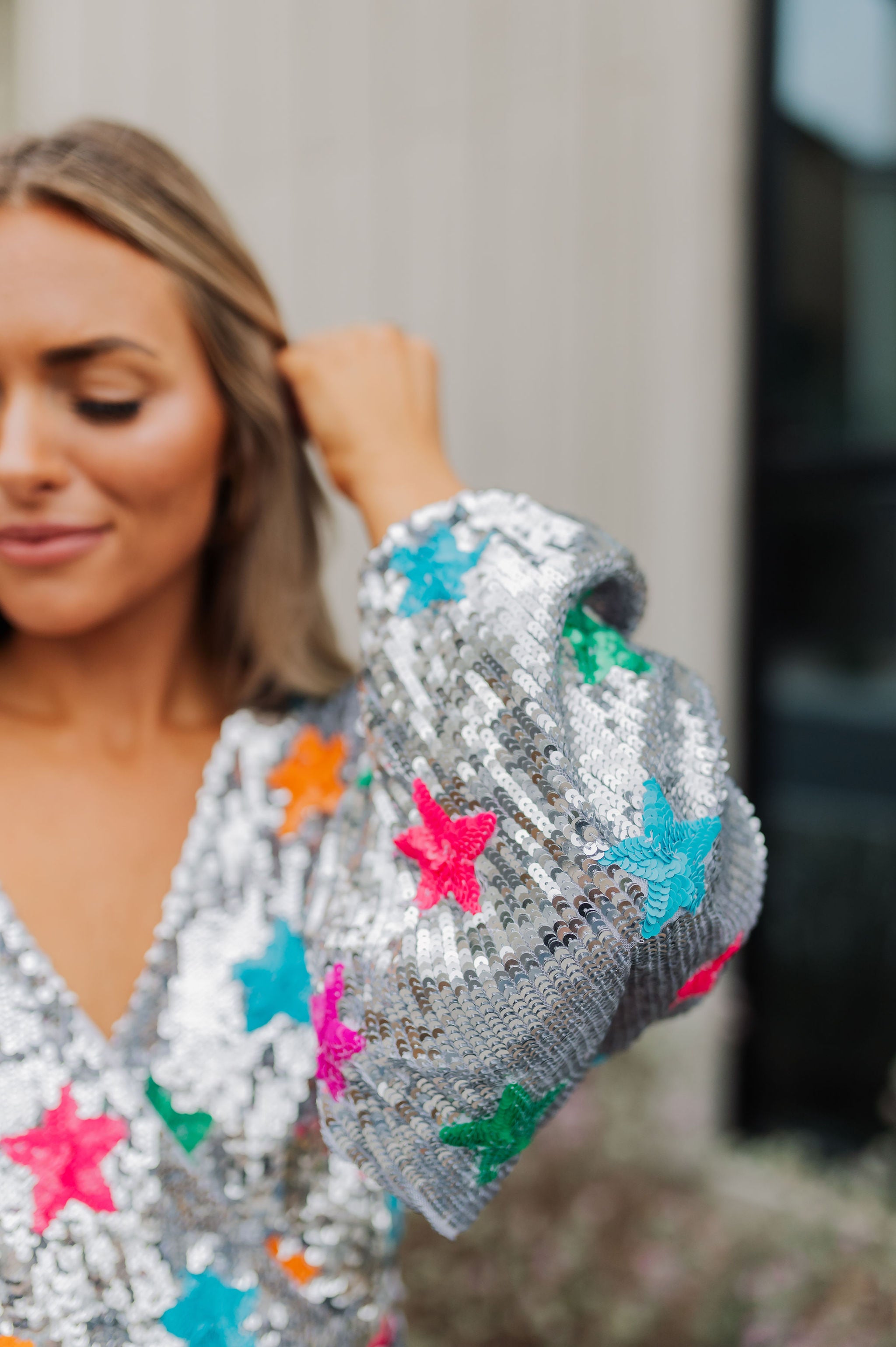 Up close view of Wear Me Out Dress sleeve showing sequin details. 