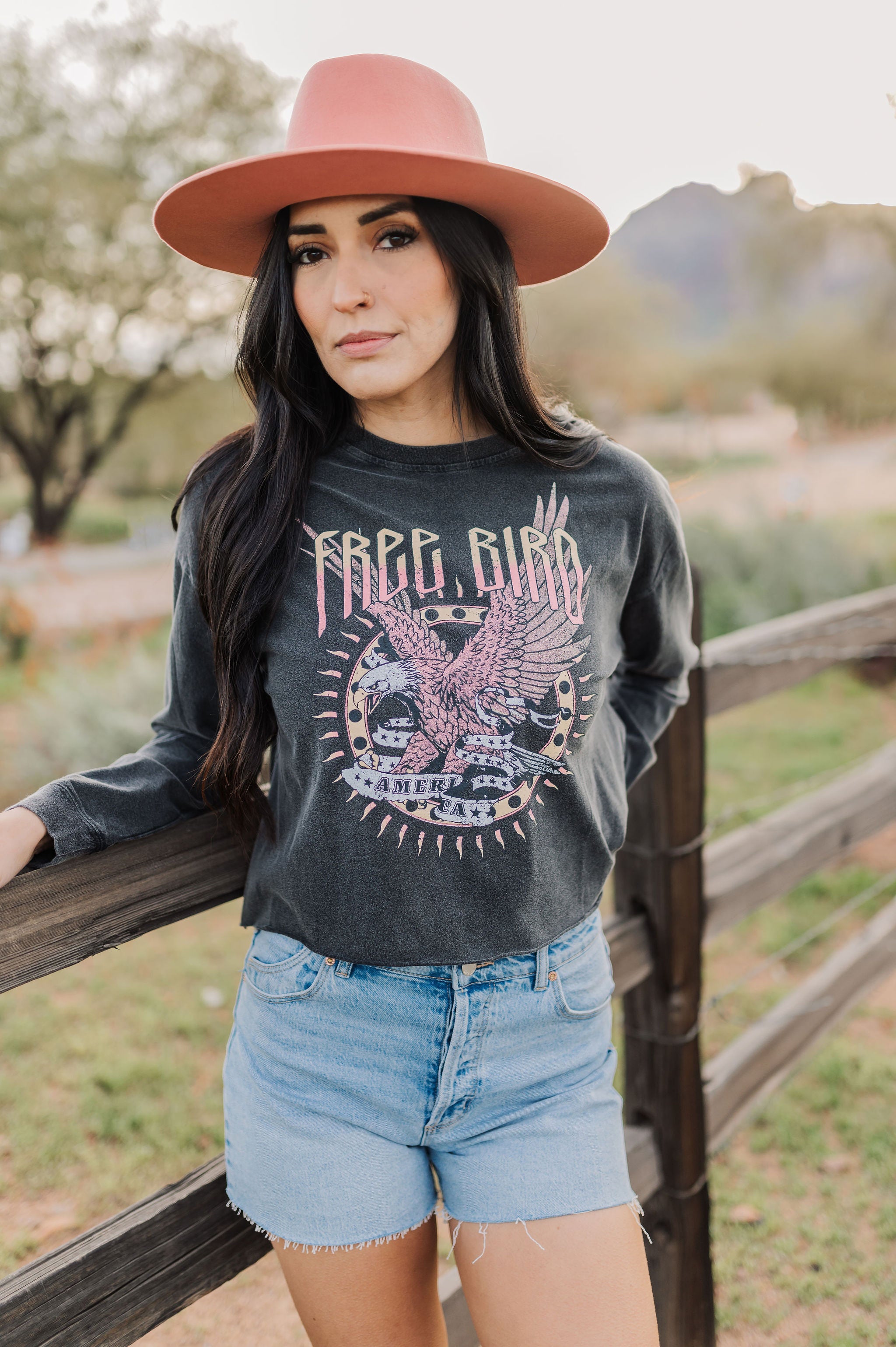 Front view of cropped Freebird Long Sleeve Graphic Tee with distressed graphic and raw hem. 