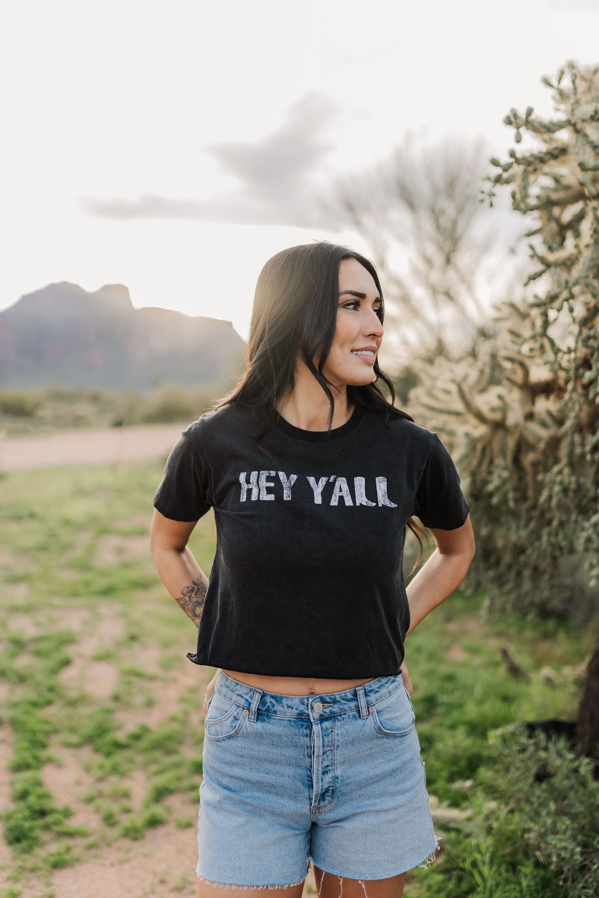 Front view of Hey Y'all Graphic Tee in mineral wash, distressed graphic, and raw hem. 