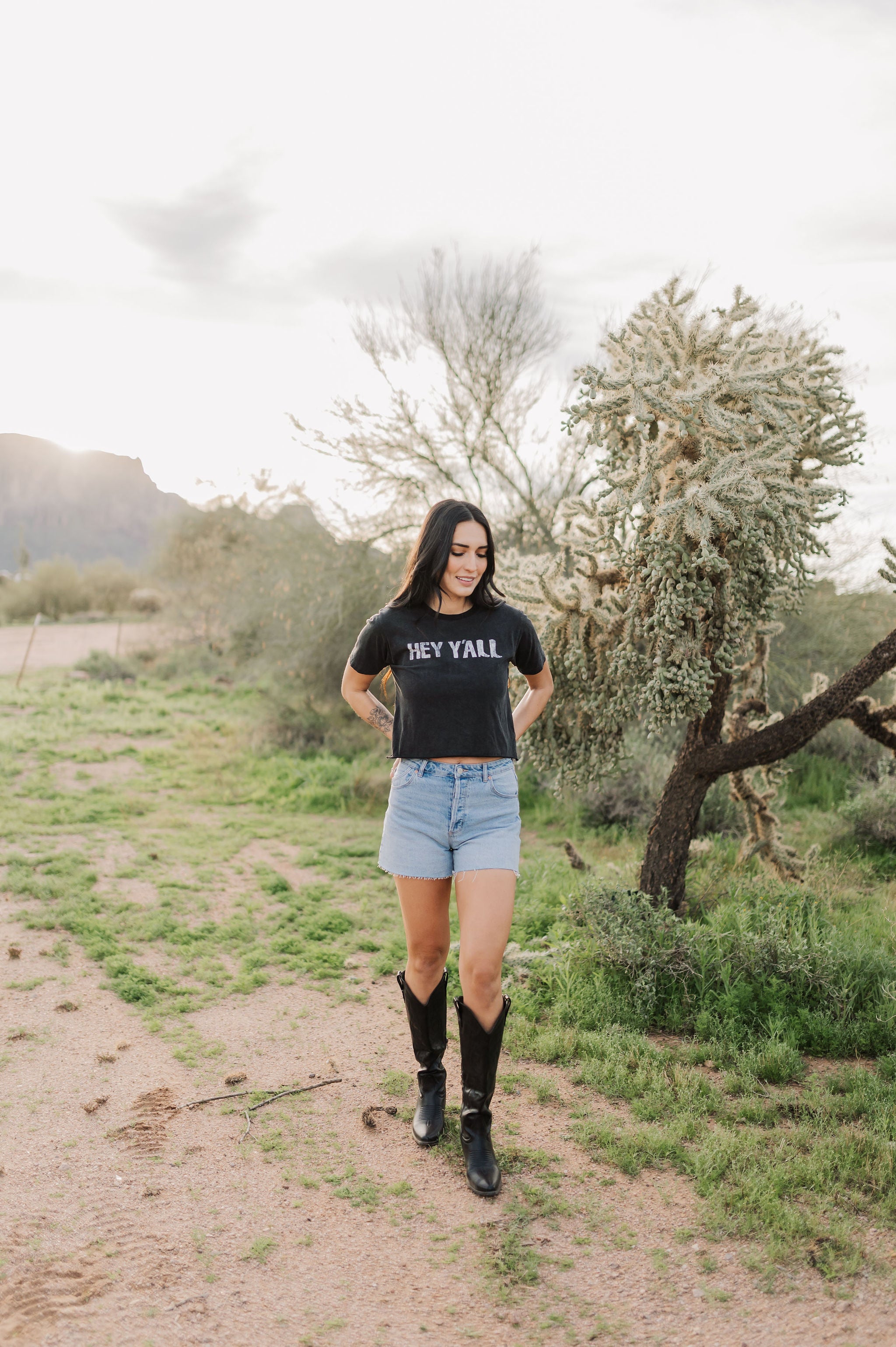 Front view of Hey Y'all Graphic Tee in mineral wash, distressed graphic, and raw hem. 