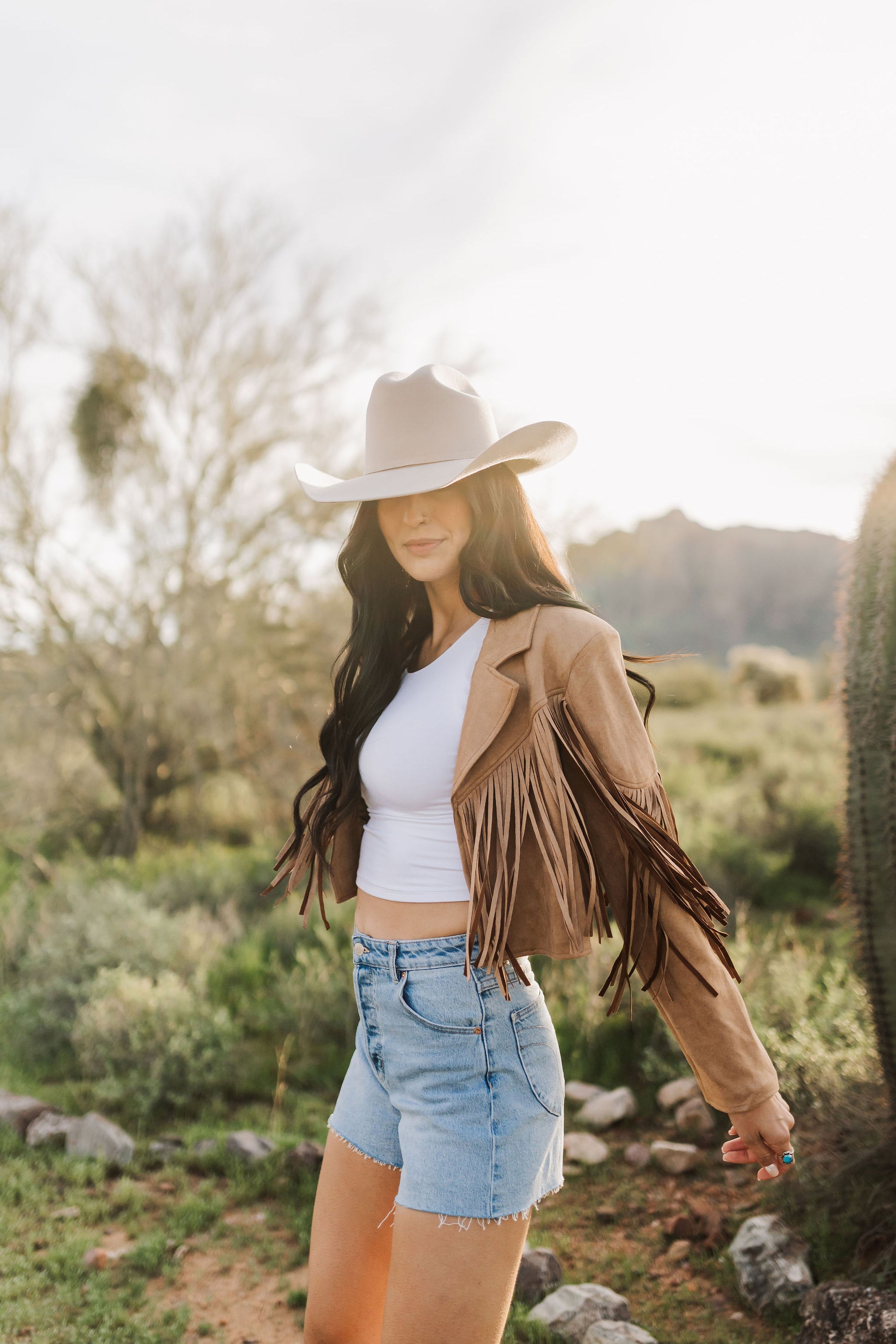 Side view of cropped Cooper Fringed Suede Jacket with tassels. 