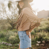 Side view of cropped Cooper Fringed Suede Jacket with tassels. 