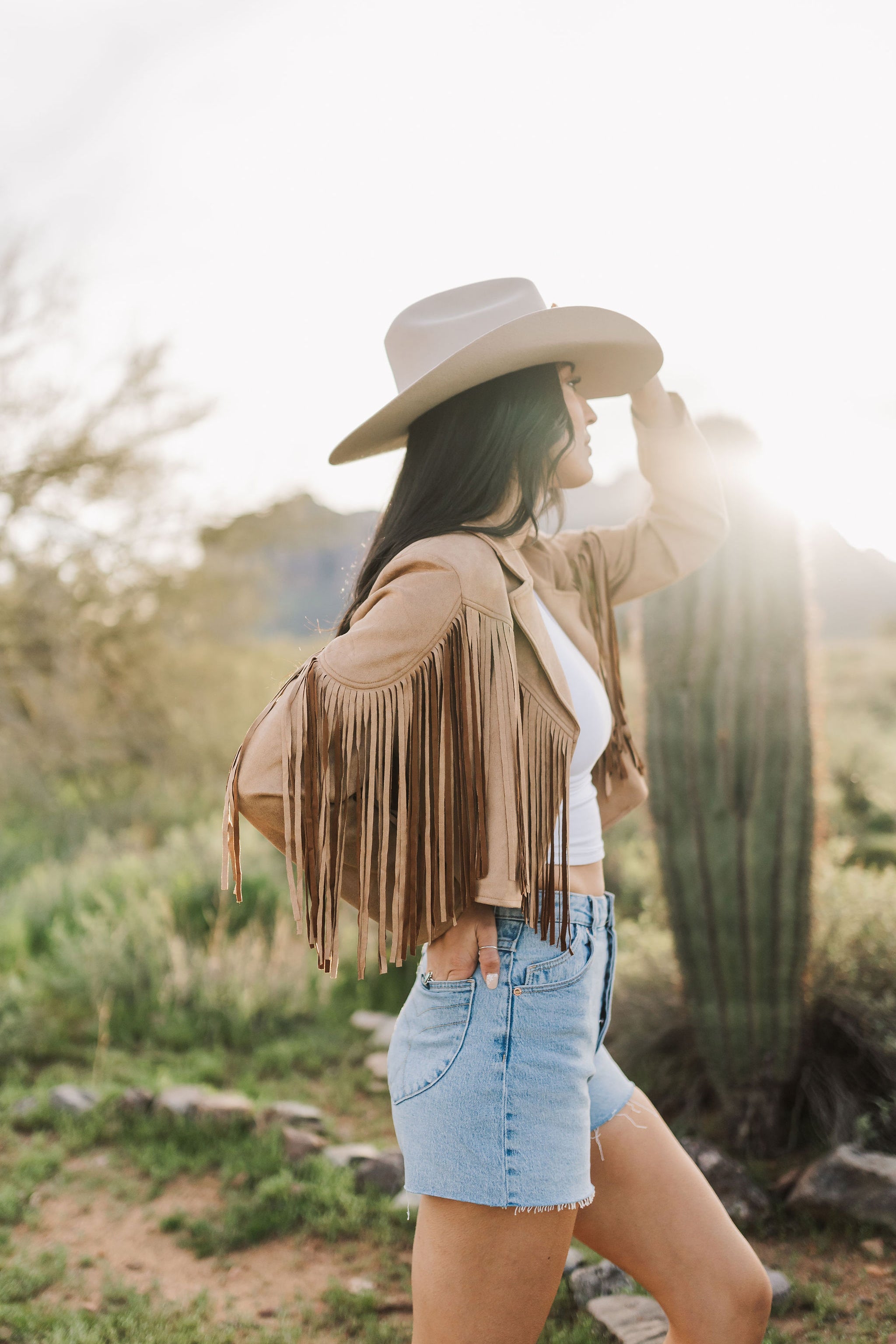 Side view of cropped Cooper Fringed Suede Jacket with tassels. 