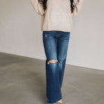 Front view of Ocean View High Rise Wide Leg Jean with raw hem and distressed legs.