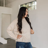 Front angled view of natural Ryleigh Sweater with rolled mock neck.