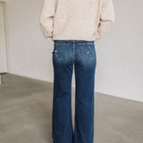 Rear view of Ocean View High Rise Wide Leg Jean with raw hem and distressed legs.