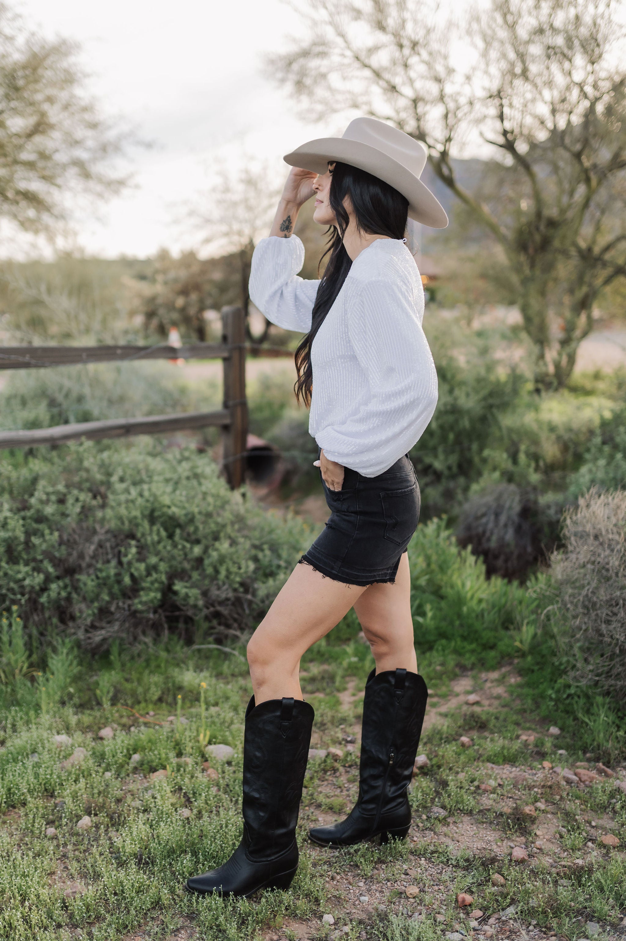 Side view of distressed Rebecca Shorts with raw hem. 