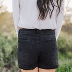 Rear view of distressed Rebecca Shorts with rear pockets and raw hem.