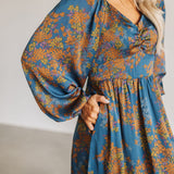 Close up front view of Sweetheart Long Sleeve Maxi Dress with floral design, puff sleeves, and pockets.