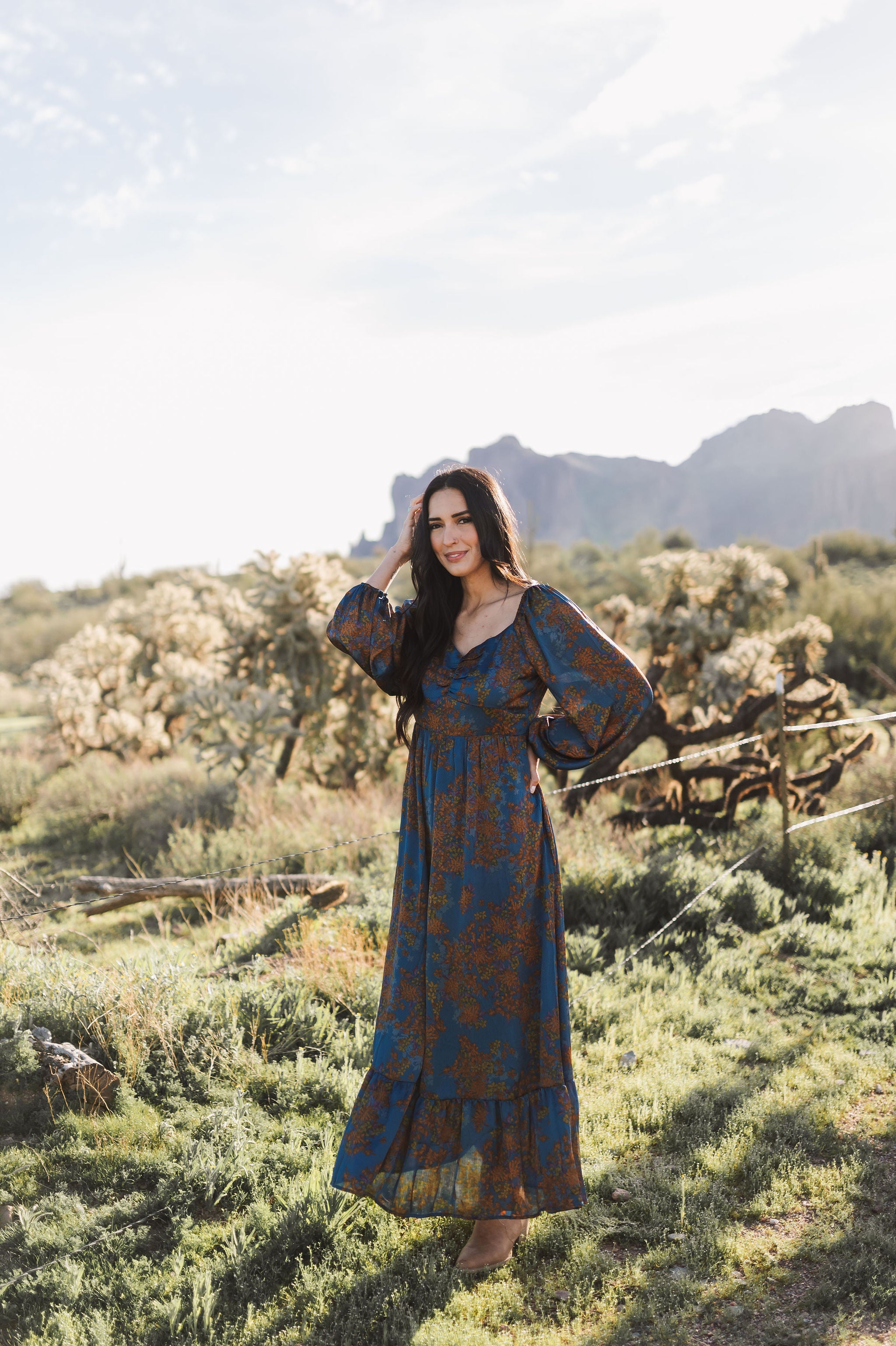 Front angled view of Sweetheart Long Sleeve Maxi Dress with floral design, sweetheart neckline, and ruffled hem.