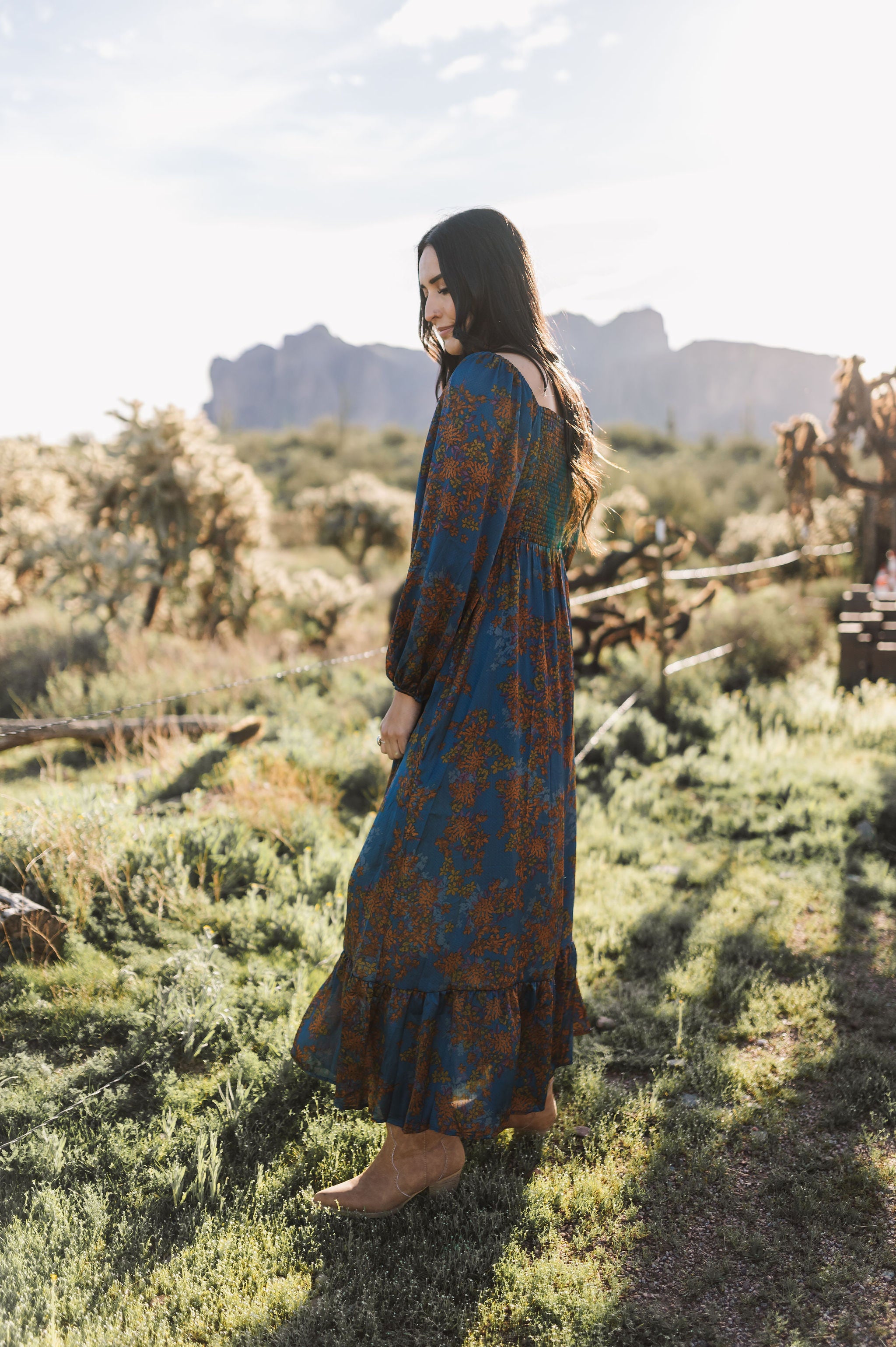 Side view of Sweetheart Long Sleeve Maxi Dress with floral design, shirred back, and ruffled hem.
