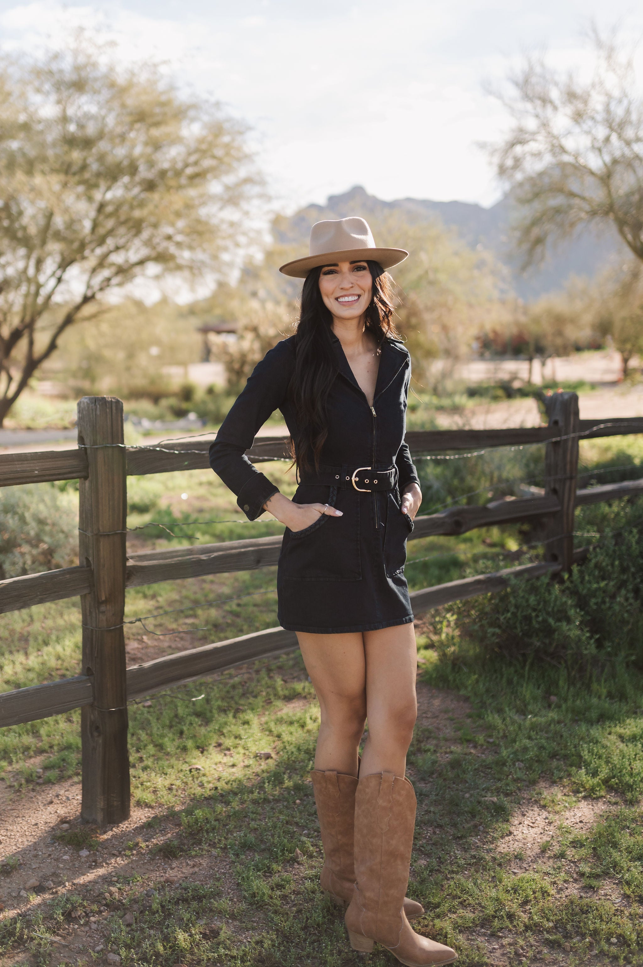 Front angled view of Outlaw Long Sleeve Dress in dark denim with zippered closure, belt, large pockets, and collared neck.