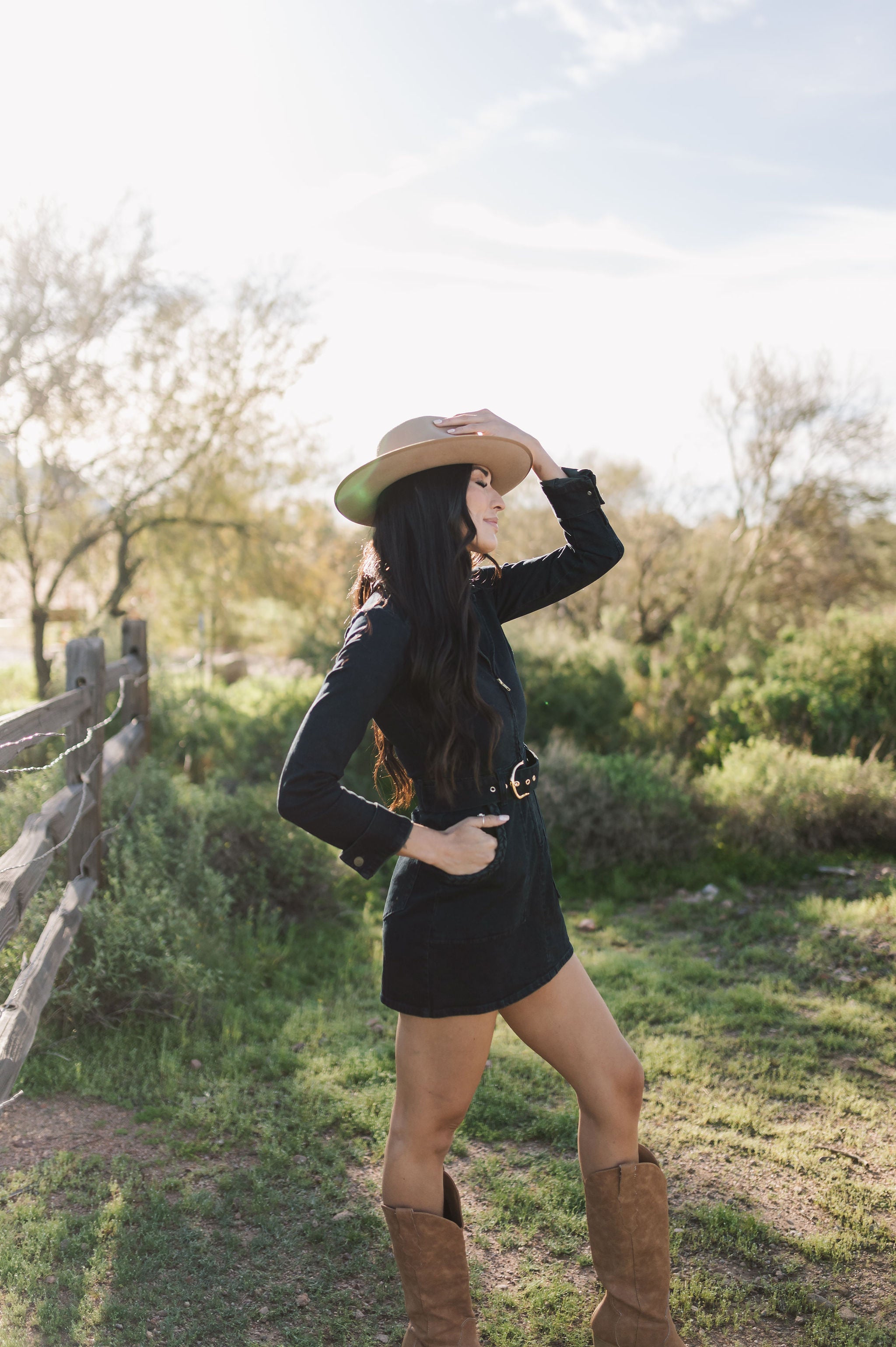 Side view of Outlaw Long Sleeve Dress in dark denim with zippered closure, belt, and large pockets.