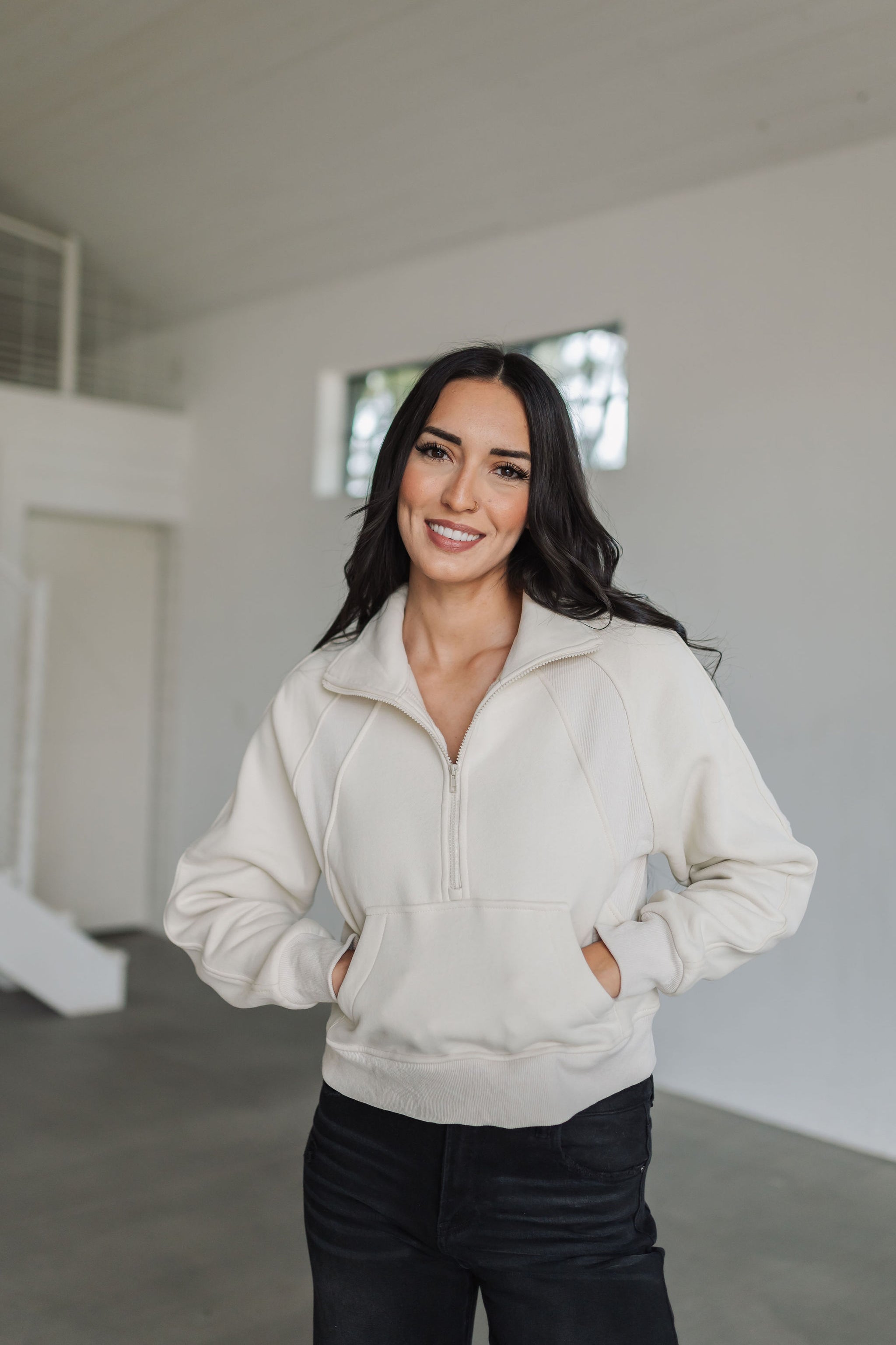 Front view of Half Zip Pullover in bone with funnel neck, kangaroo pocket, and stitch detail.