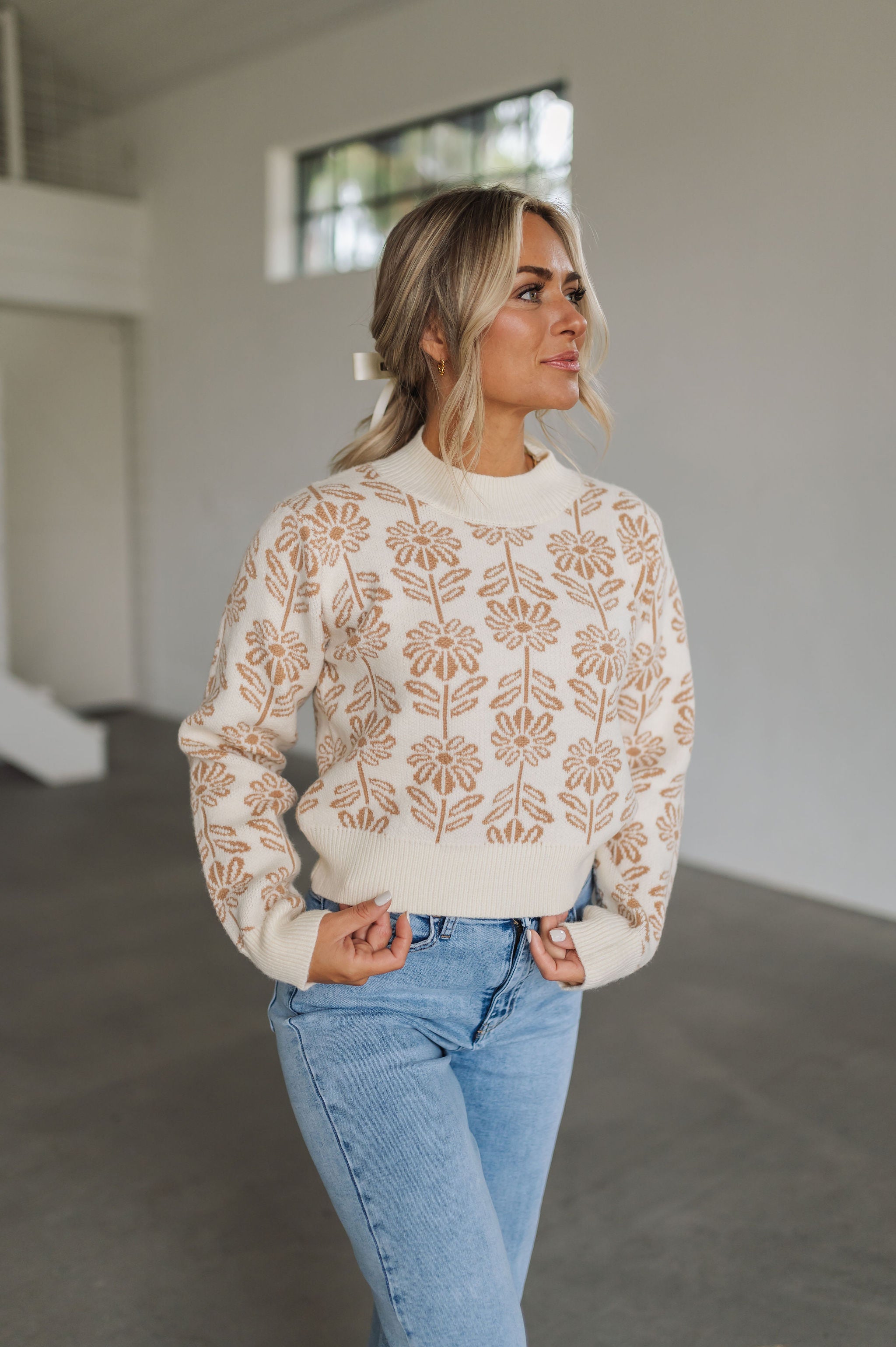 Front view of Magnolia Knit Sweater with ribbed mock neck, hem, and cuffs, and allover floral pattern. 