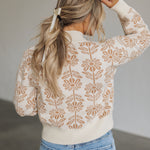 Rear view of Magnolia Knit Sweater with ribbed mock neck, hem, and cuffs, and allover floral pattern. 