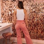 Rear view of rose colored Sailor Scoop wide leg ankle jeans.  