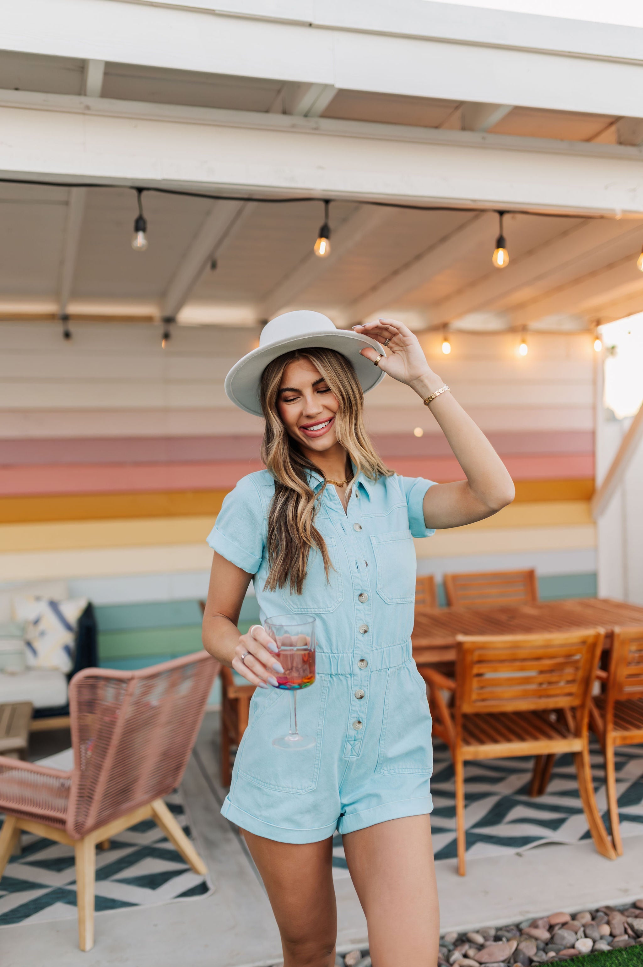 Front view of button up Cannon Romper with elastic waistband and cuffed sleeves and hem.