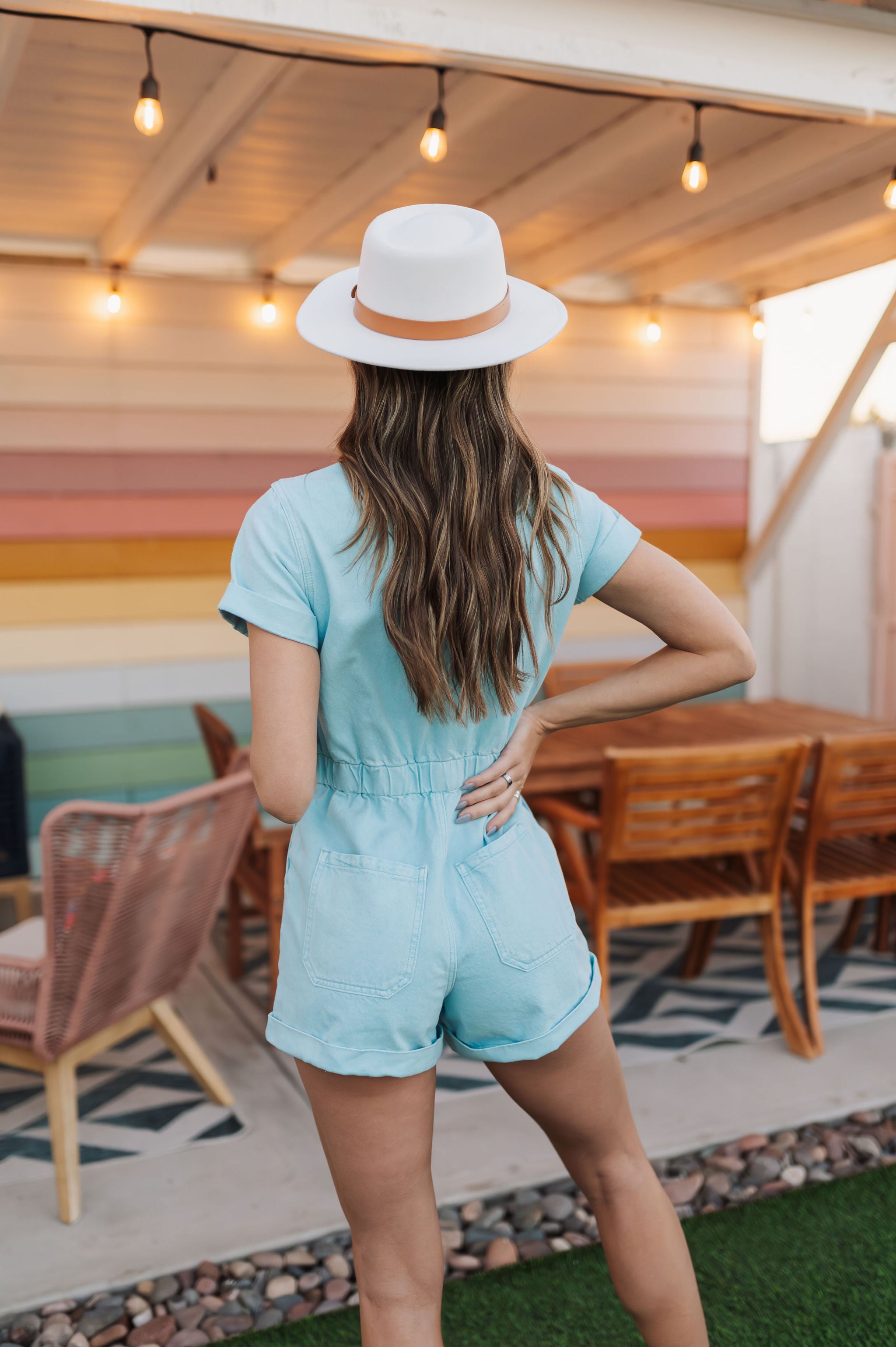 Rear view of Cannon Romper with elastic waistband, back pockets, and cuffed sleeves and hem.