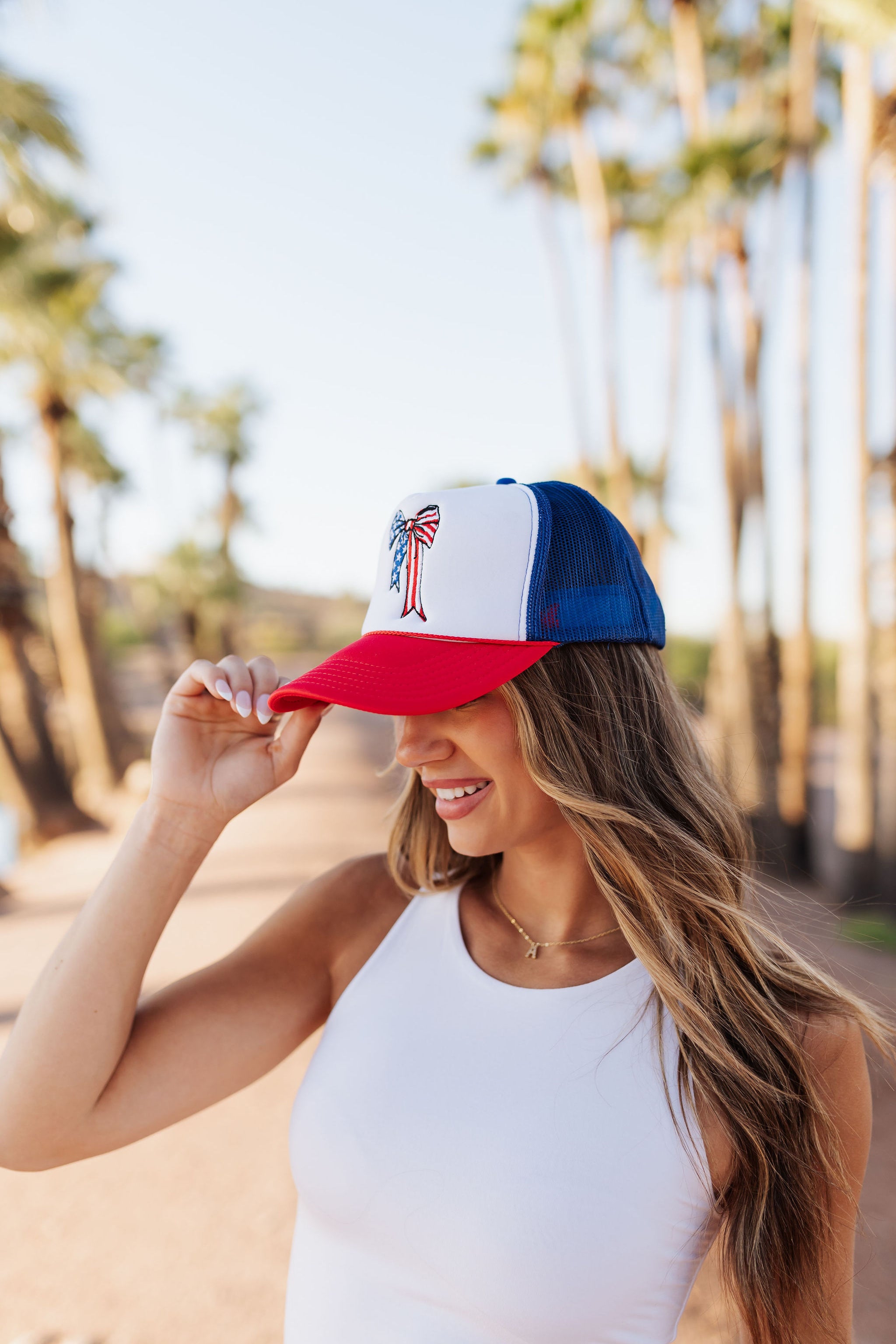 Side view of red, white, and blue USA Bow Trucker Hat.