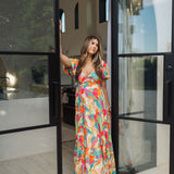 Front view of  Isle Glow Maxi Dress in allover bright floral print with short puff sleeves, sweetheart neckline, and ruffle hem. 