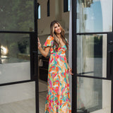 Front view of  Isle Glow Maxi Dress in allover bright floral print with short puff sleeves, sweetheart neckline, and ruffle hem. 