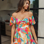 Front view of  Isle Glow Maxi Dress in allover bright floral print with short puff  off shoulder sleeves and sweetheart neckline. 