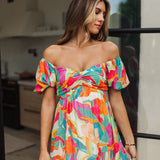 Front view of  Isle Glow Maxi Dress in allover bright floral print with short puff  off shoulder sleeves and sweetheart neckline. 