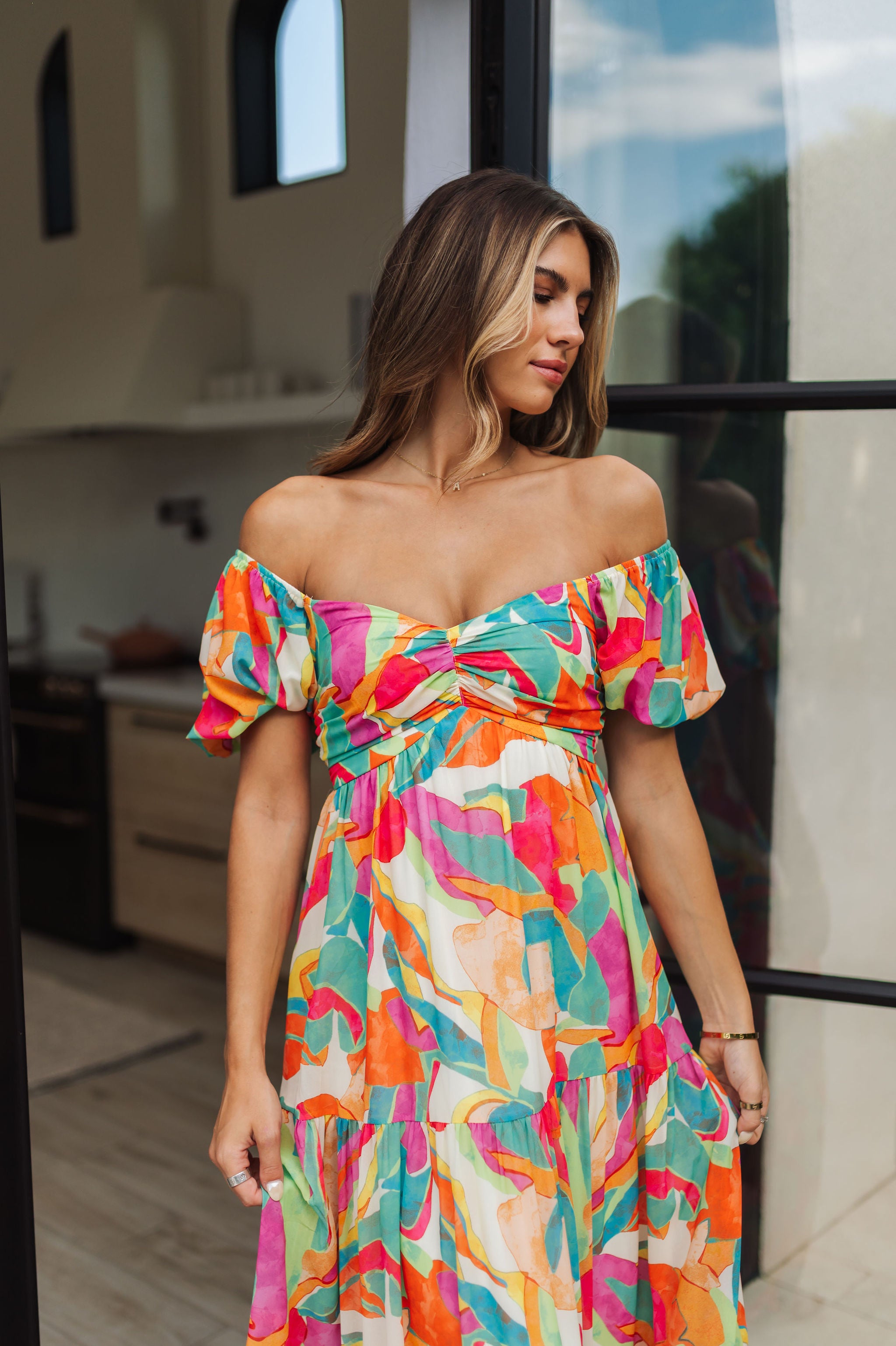 Front view of  Isle Glow Maxi Dress in allover bright floral print with short puff  off shoulder sleeves and sweetheart neckline. 