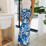 Front angled view of Coastal Breeze Pants in blue and white tropical print with wide legs and front tie. 