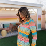 Side angled view of multi-striped crochet Vacay Coverup with long sleeves and tie front.