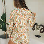 Rear view of Early Riser PJ Set in allover western graphic with long sleeves and short bottoms. 